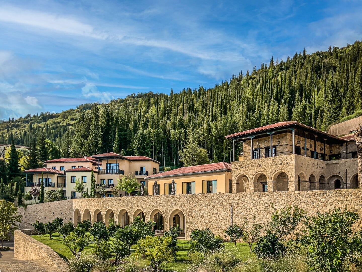 Level view of the buildings of Euphoria Retreat nestled at the foothills of a verdant forest.
