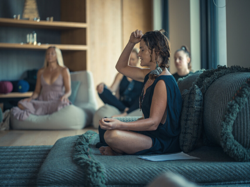 Woman practicing mindfulness during a group session at Euphoria Retreat, the best spa for solos in Greece.